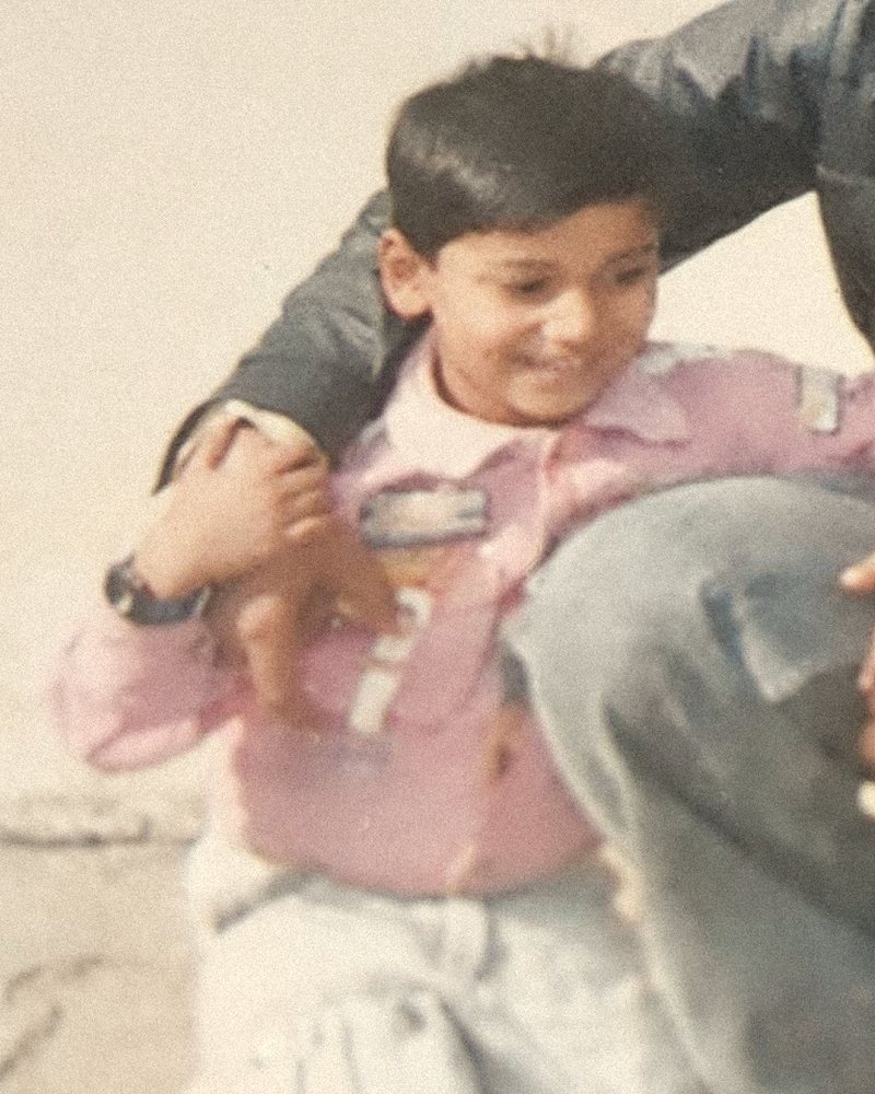 Faraz as a kid, smiling, in a faded family photo