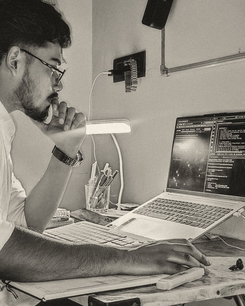 Faraz at his desk, studying a terminal on his laptop